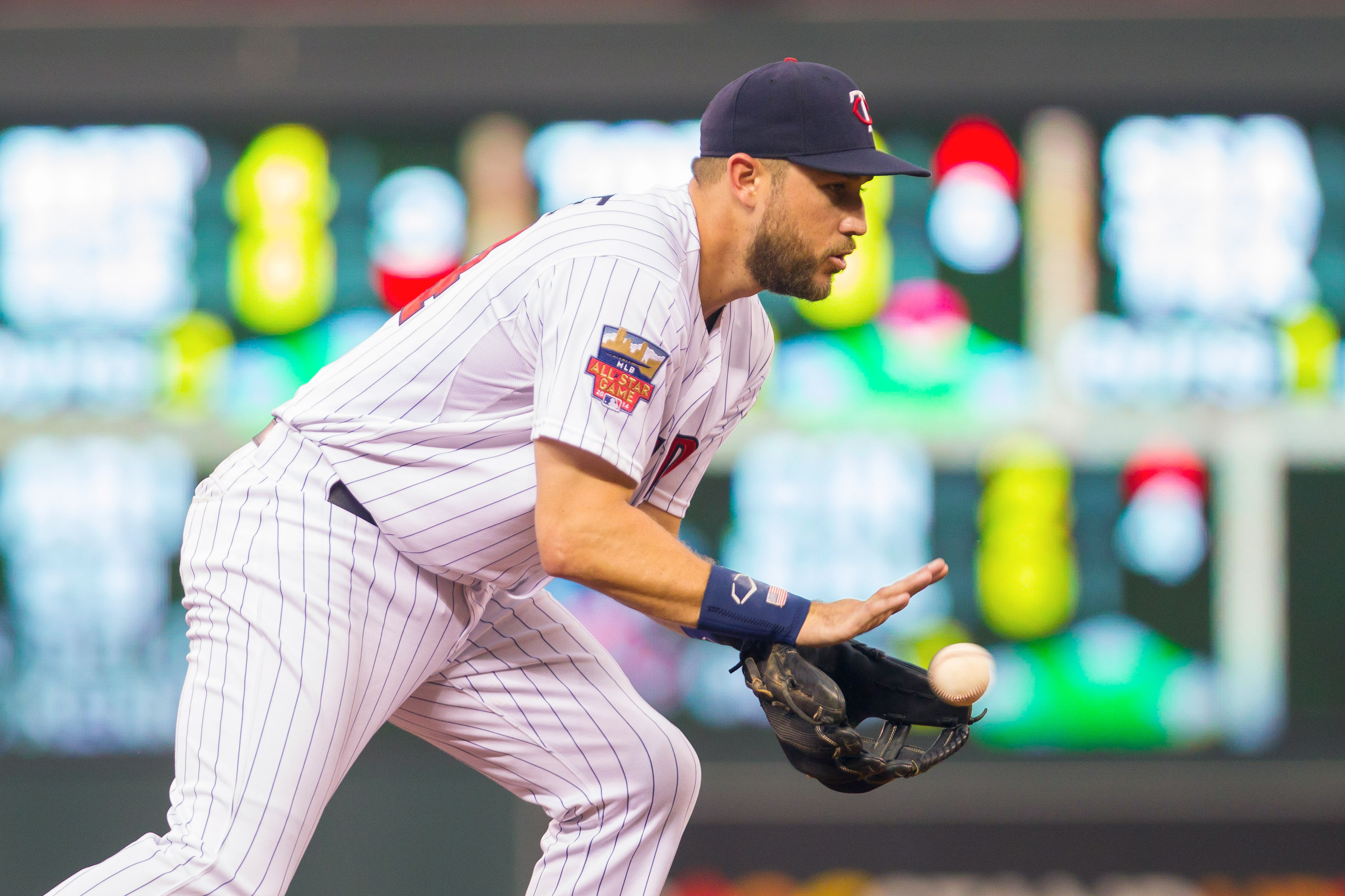 Trevor Plouffe of the Minnesota Twins looks on and points at the